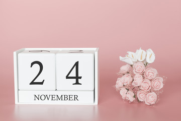 November 24th. Day 24 of month. Calendar cube on modern pink background, concept of bussines and an importent event.