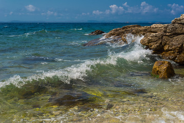 Waves breaking on a stony beach in Murter, Croatia, Dalmatia