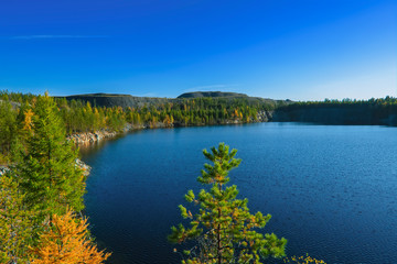 Autumn landscape sunset in the forest near the lake in the Ural Mountains