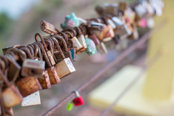 Lock for couple make a promise to love forever, master keys hanging on the rails of bridge, the sign of love and romantic affection as a landmark. Symbolic love locks hang along.