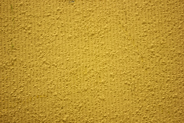 Yellow background texture.Facade plaster painted with yellow paint