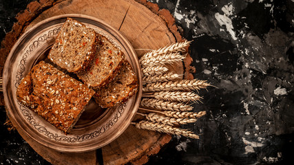 Sliced rye bread on cutting board. Whole grain rye bread with seeds for healthy balanced diet and avitaminosis prevention