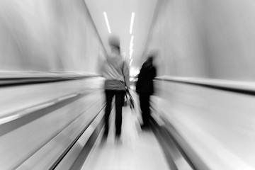 Commuters on escalator at subway station