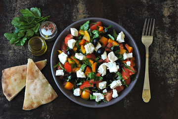 Middle Eastern cuisine. Vegetable salad with feta and parsley. Bright nutritious salad with feta vegetables and pita.
