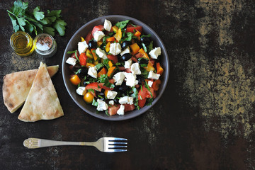 Middle Eastern cuisine. Vegetable salad with feta and parsley. Bright nutritious salad with feta vegetables and pita.
