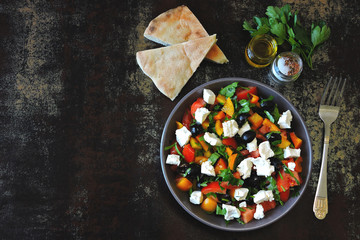 Middle Eastern cuisine. Vegetable salad with feta and parsley. Bright nutritious salad with feta vegetables and pita.
