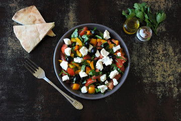 Middle Eastern cuisine. Vegetable salad with feta and parsley. Bright nutritious salad with feta vegetables and pita.