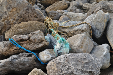 Fishing net and ropes left behind on rocks