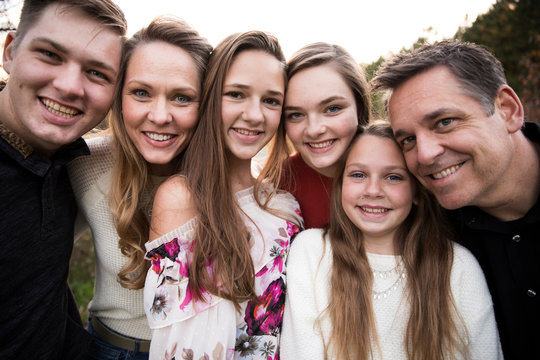 Close View Of Faces Of Happy Smiling Large Family Of Teenagers