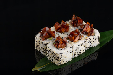 Sushi roll set with sesame and caramel soy sauce.