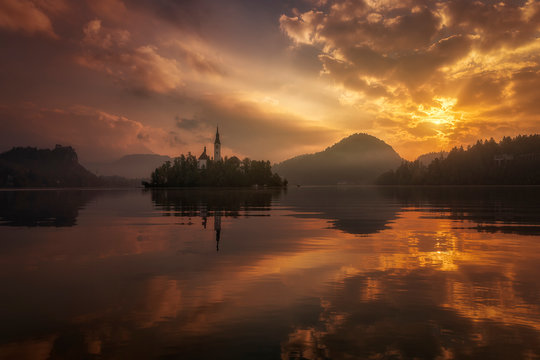 Orange sunset with a magic atmosphere in Bled lake, Slovenia.