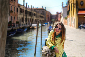 Fototapeta na wymiar young woman on Venice canal background 