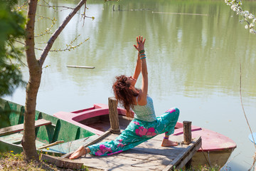 young woman practice yoga outdoor by the lake healthy lifestyle concept sumer day