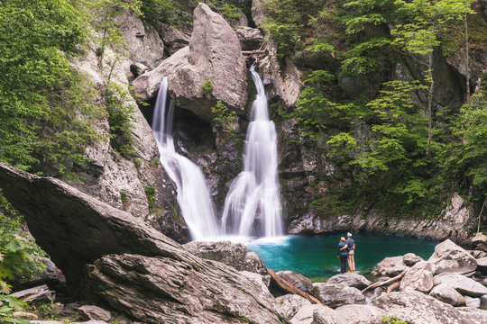 Couple look on at Bash Bish Falls after hiking in MA