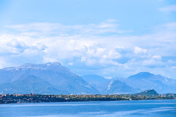 lake in the mountains with blue clouds and high rocks 