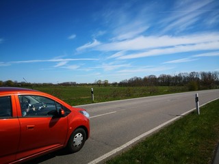 Fototapeta na wymiar Red car on empty country road