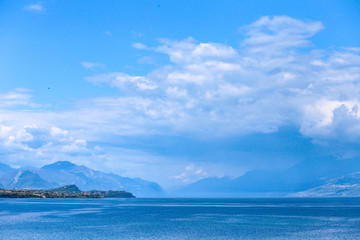 lake in the mountains with blue clouds and high rocks 