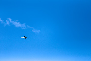 small plane in blue sky 