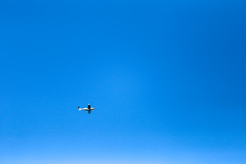 small plane in blue sky 