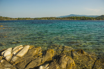 tropic Asian scenic landscape rocky beach waterfront sea lagoon surrounded by island shoreline 