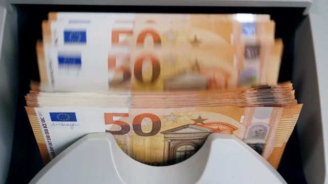 Money-counting machine with euros in it