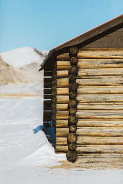 side of old barn with blue skies and buttes