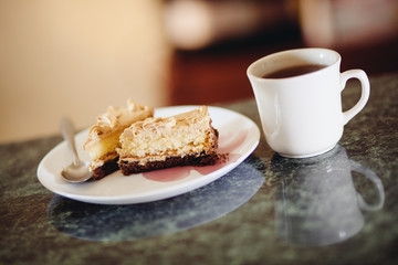 Dessert eating - cup of tea or coffee and sweet cake with chocolate