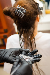 Fototapeta na wymiar Zabieg keratynowy u fryzjera - Keratin treatment at the hairdresser