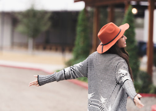 Brunette twirling in the streets.