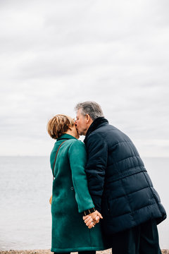 View From Behind Of An Older Couple Kissing