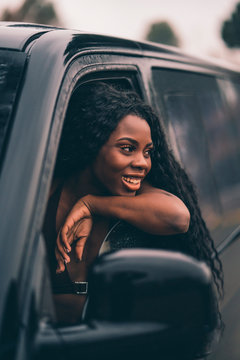 Nice african woman in car window.
