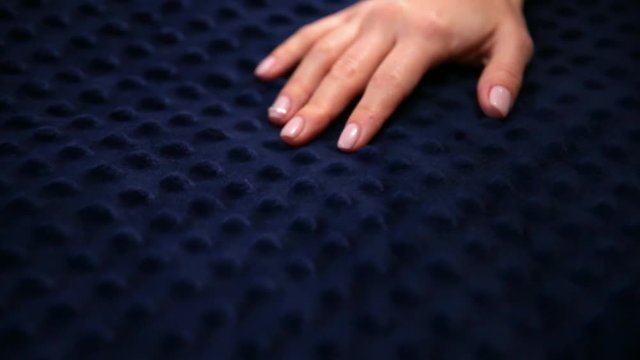 Female hand touching soft and clean blue bubble blanket