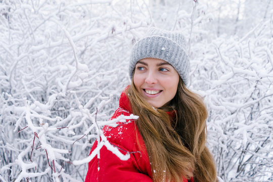 close-up laughing woman in red down jacket on a winter background