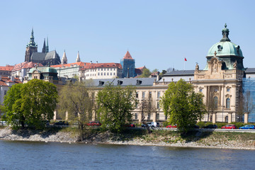 Spring green Prague Lesser Town with gothic Castle above River Vltava in the sunny Day, Czech...