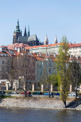 Spring green Prague Lesser Town with gothic Castle above River Vltava in the sunny Day, Czech Republic