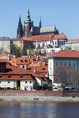 Spring green Prague Lesser Town with gothic Castle above River Vltava in the sunny Day, Czech...