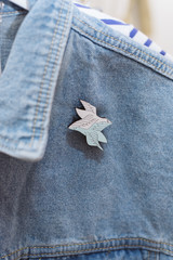 brooch on jeans. Denim style. Icon on clothes