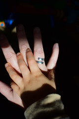 Child's hand on top of Mom's hand