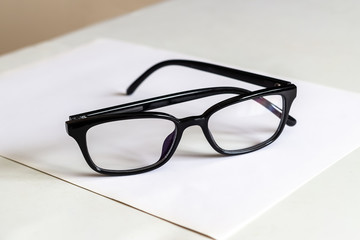 Folded glasses on white table