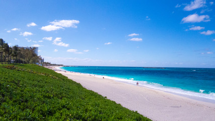Sunny day over a beautiful beach from Nassau and the Atlantic Ocean. Paradise Island, The Bahamas.