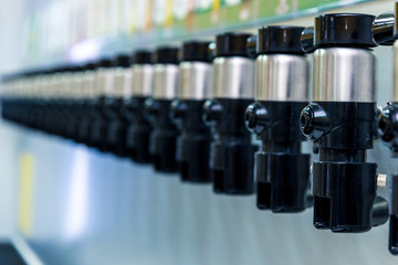 many modern faucets for pouring beer in a row. Horizontal frame