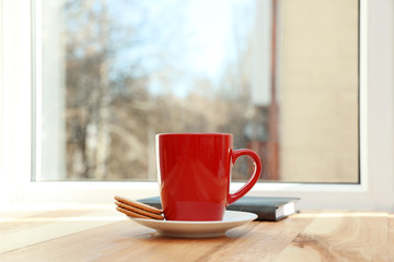 Cup of hot winter drink and cookies on wooden windowsill, space for text