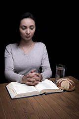 Woman praying indoors