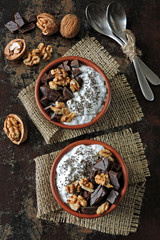 Keto breakfast or dessert. White yogurt with chia, walnuts and dark chocolate. Useful energy food. Eco food. Superfoods