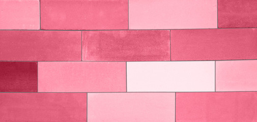 A set of the pink-colored ceramic bricks made in a wall