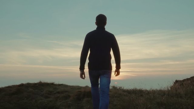 The man walking on a picturesque mountain