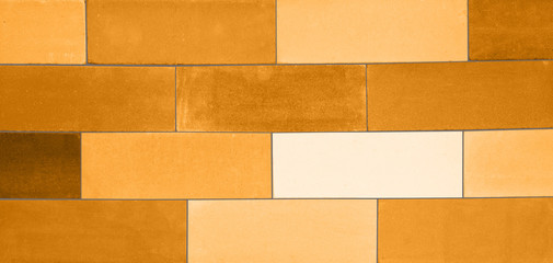 A set of the yellow-colored ceramic bricks made in a wall