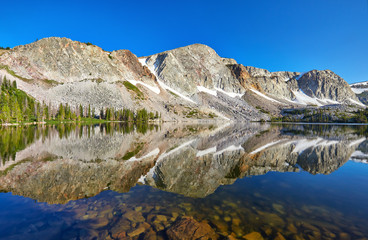 Fototapeta na wymiar Reflection at Lake Marie, located along the Snowy Range Scenic Byway in the Medicine Bow mountains (a.k.a., the Snowy Range) of Wyoming