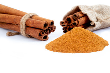Top view cinnamon sticks and powder, isolated on white background.