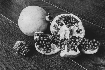 pomegranate fruits on a dark surface